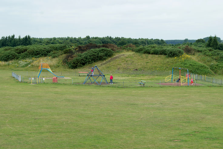 People playing in a park play area.